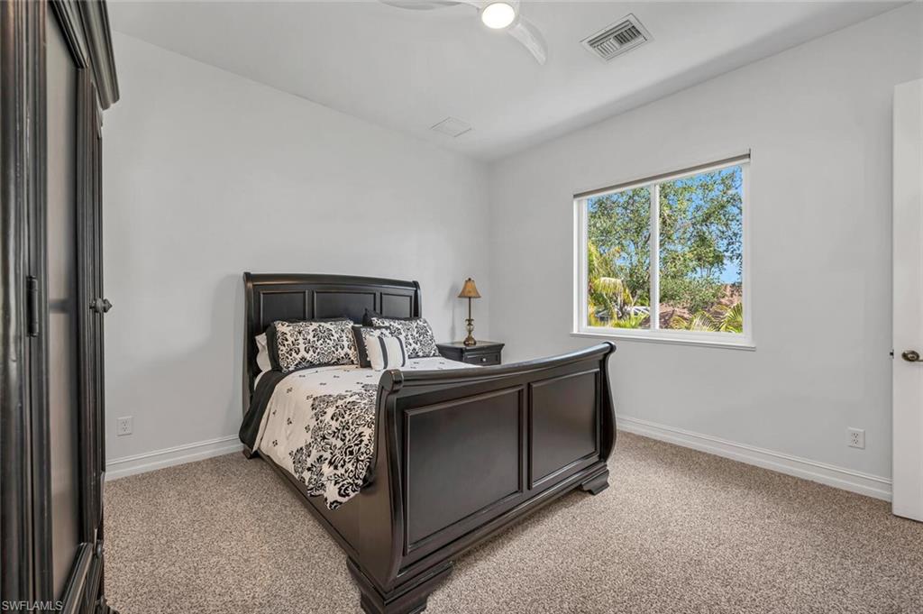 2067 Mission Drive Naples, FL 34109 - Photo 32 of 43 a bed sitting in a bedroom next to a window