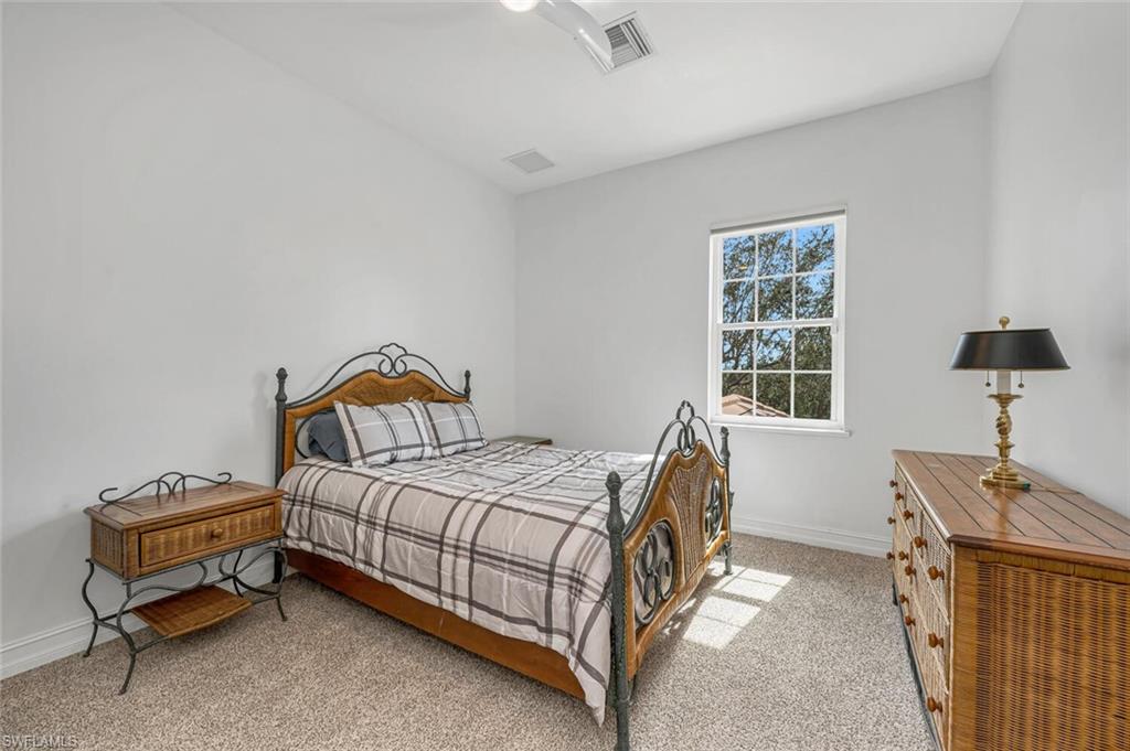 2067 Mission Drive Naples, FL 34109 - Photo 33 of 43 a bedroom with a bed and a window