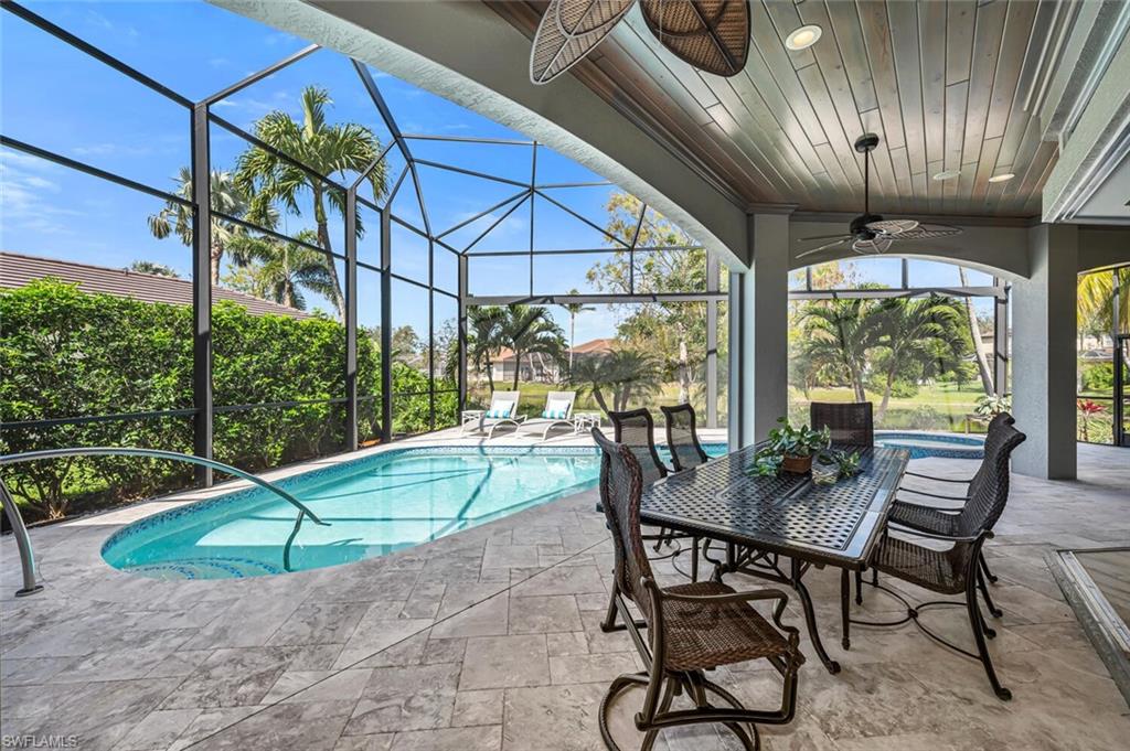 2067 Mission Drive Naples, FL 34109 - Photo 4 of 43 a table and chairs in patio