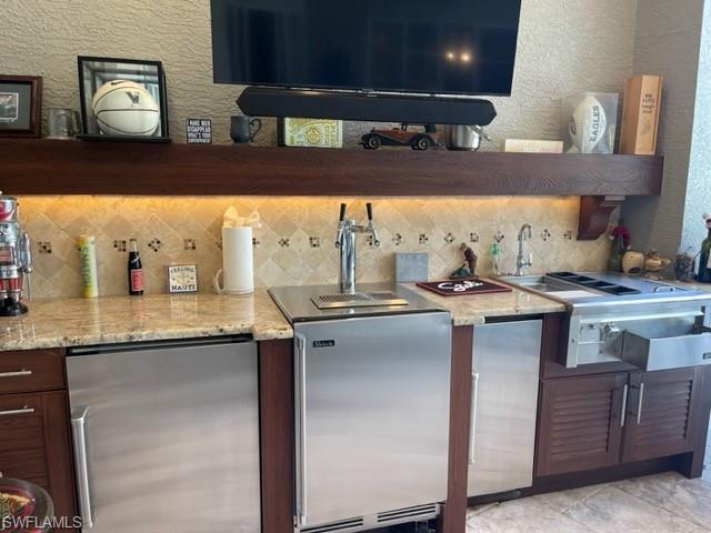 2067 Mission Drive Naples, FL 34109 - Photo 9 of 43 a kitchen with stainless steel appliances granite countertop a sink and cabinets