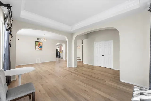 a view of empty room with wooden floor