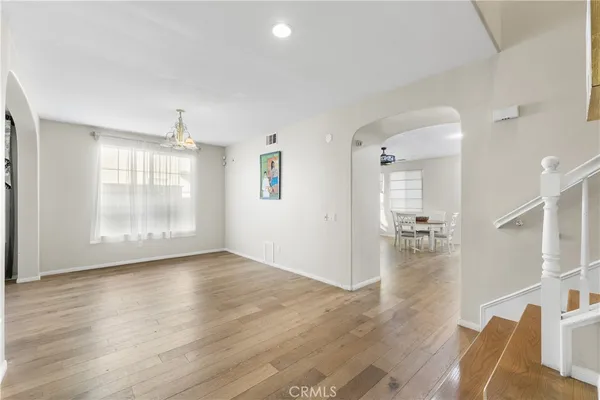 a view of a room with wooden floor lounge chair and windows