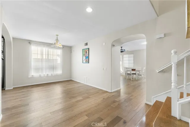 a view of a room with wooden floor lounge chair and windows