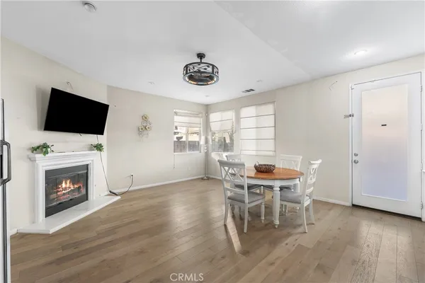 a dining room with furniture and wooden floor