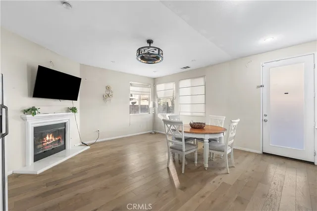 a dining room with furniture and wooden floor