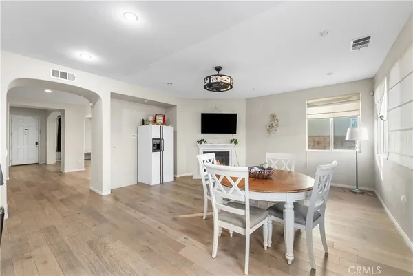 a large kitchen with stainless steel appliances kitchen island a large counter top and a wooden floors