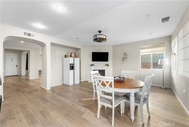a large kitchen with stainless steel appliances kitchen island a large counter top and a wooden floors