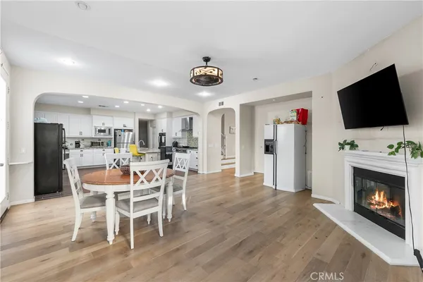 a large kitchen with stainless steel appliances kitchen island granite countertop a refrigerator and a stove top oven