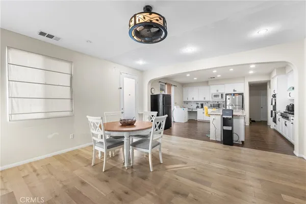 a kitchen with granite countertop a sink stove and refrigerator