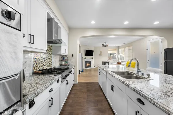 a living room with furniture a flat screen tv and a window