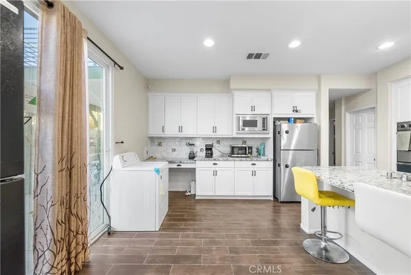 a view of an empty room with wooden floor and closet