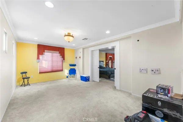 a bedroom with a bed and a view of walk in closet