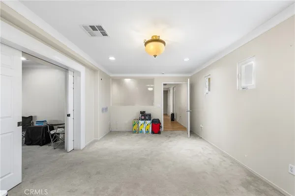 a view of a hallway with wooden floor and windows