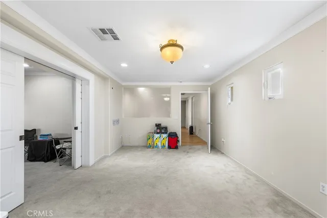a view of a hallway with wooden floor and windows