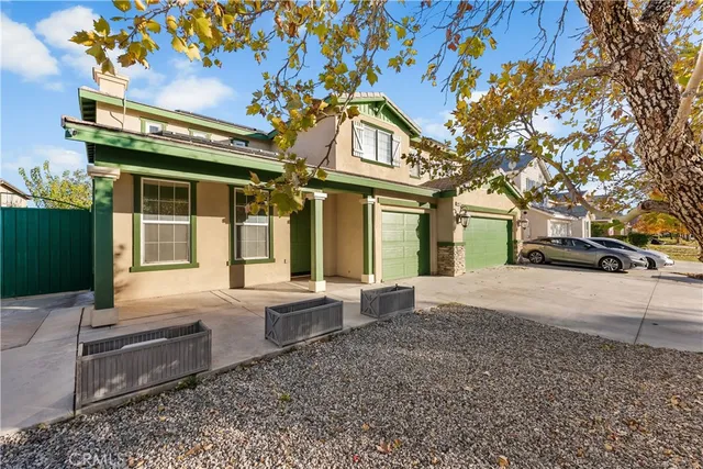 a view of a house with a large tree
