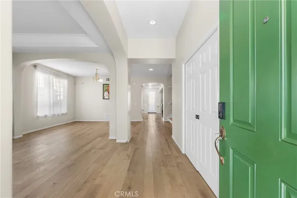 a view of a hallway with wooden floor and staircase