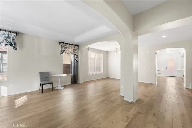 a view of a livingroom with furniture wooden floor and a window