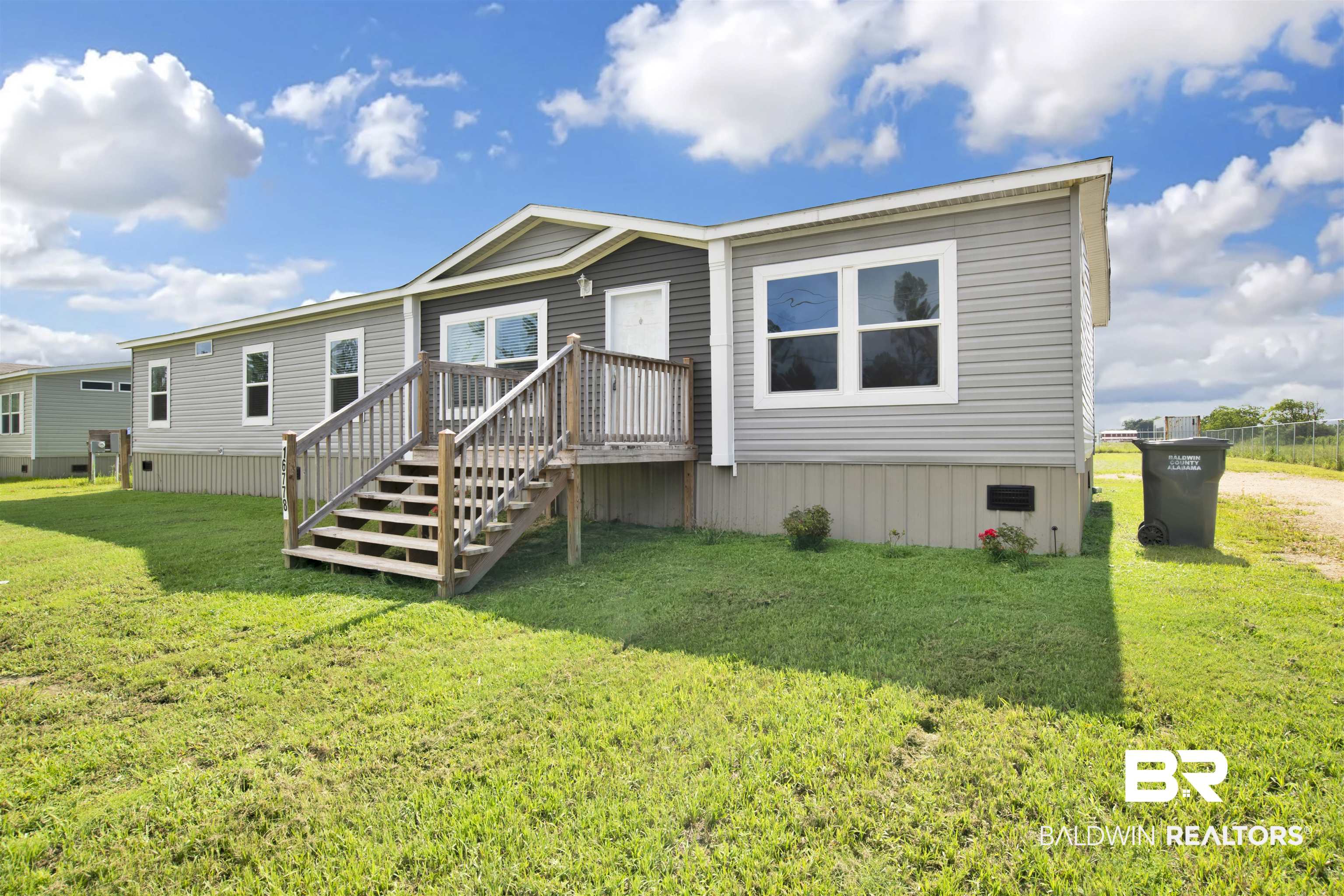 16778 County Road 87 Elberta, AL 36530 - Photo 4 of 32 Rear view of house featuring a wooden deck and a yard