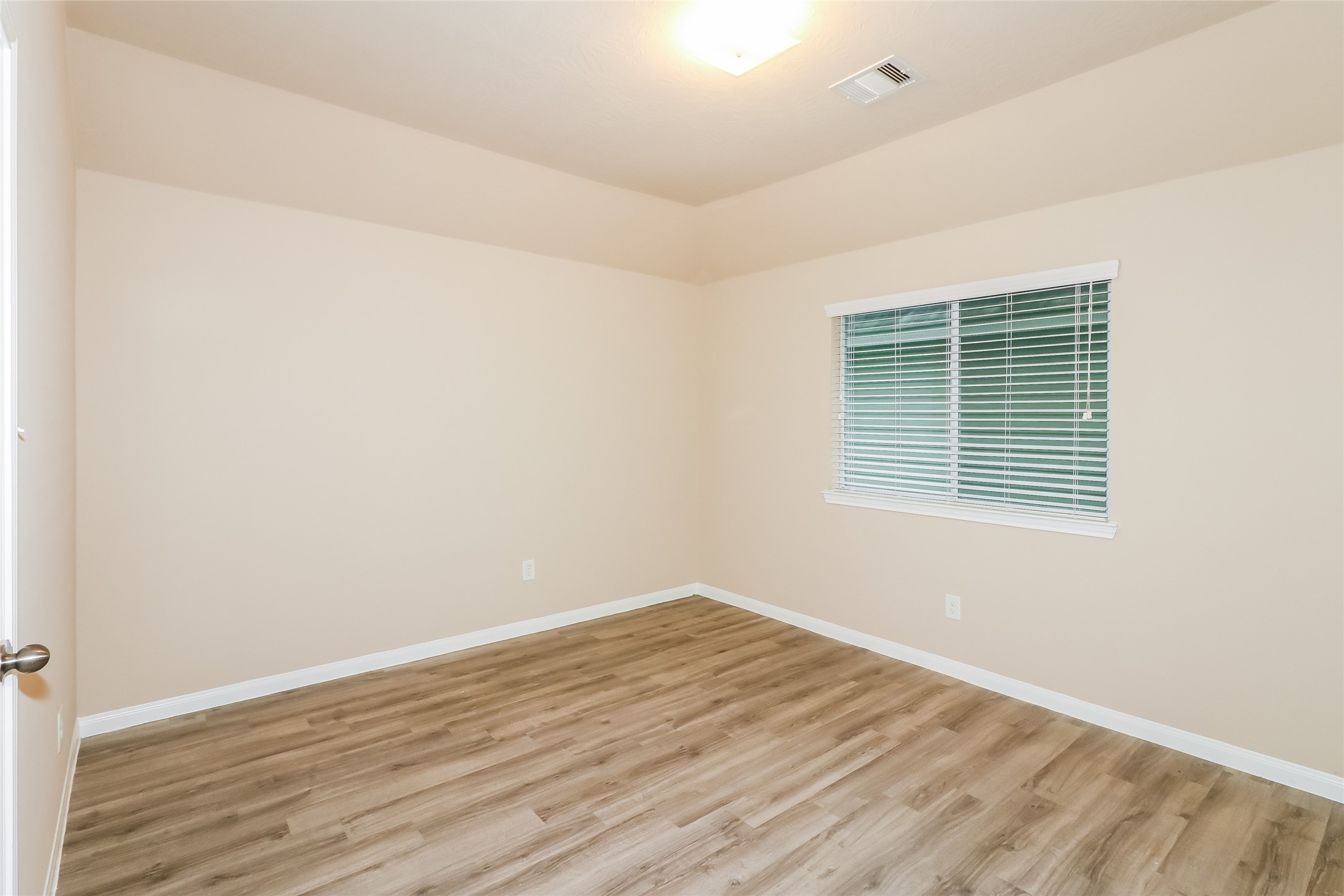 19006 Treviso Terrace Lane Katy, TX 77449 - Photo 8 of 17 an empty room with wooden floor and a window