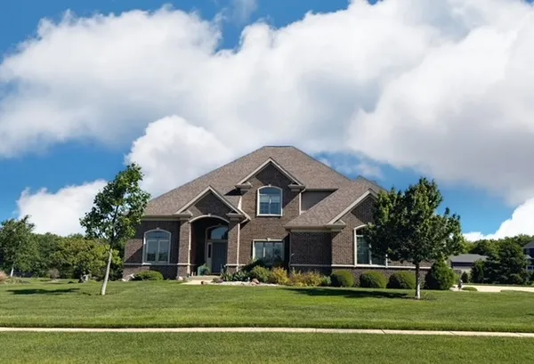 a front view of a house with a garden
