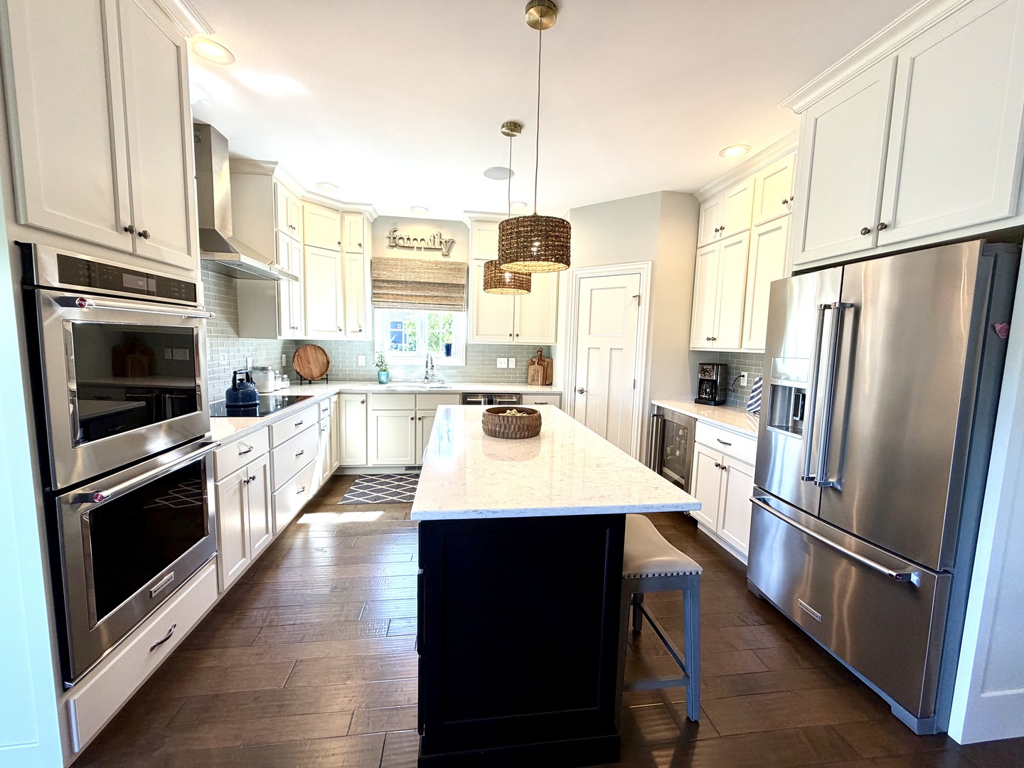 400 Constitution Boulevard Monticello, IL 61856 - Photo 19 of 58 a kitchen with stainless steel appliances a stove a refrigerator a sink a oven and a refrigerator with wooden floor