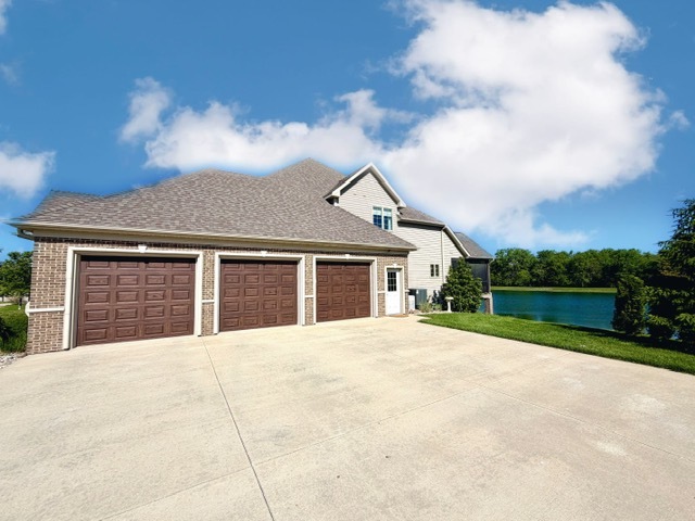 400 Constitution Boulevard Monticello, IL 61856 - Photo 4 of 58 a front view of a house with yard and garage