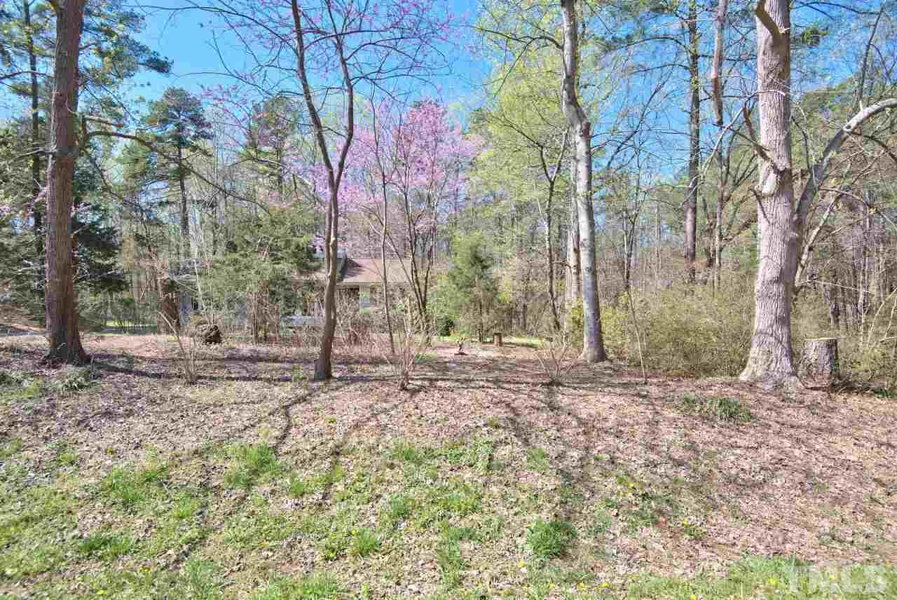 6017 Crabapple Road Durham, NC 27712 - Photo 2 of 18 a backyard of a house with lots of green space