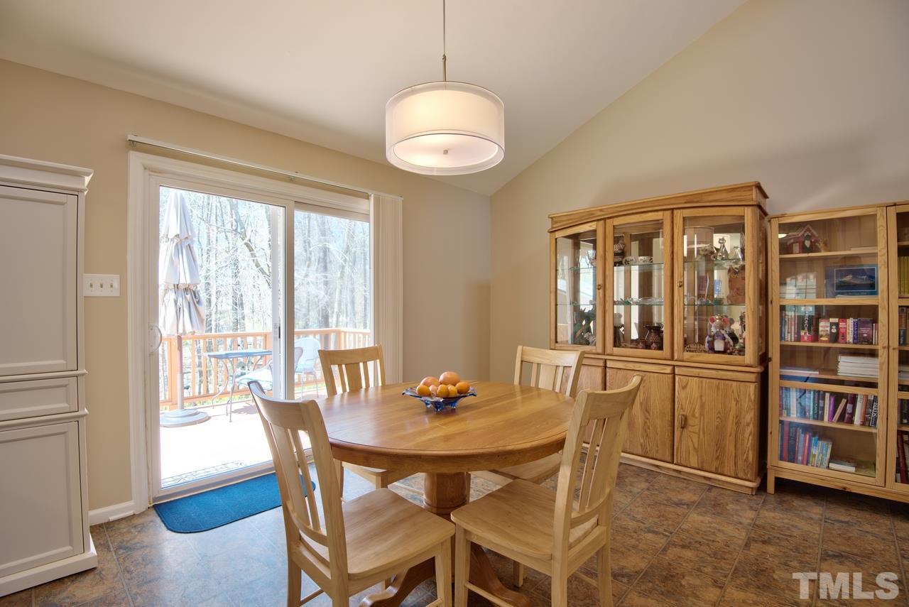 6017 Crabapple Road Durham, NC 27712 - Photo 12 of 18 a view of a dining room with furniture window and wooden floor