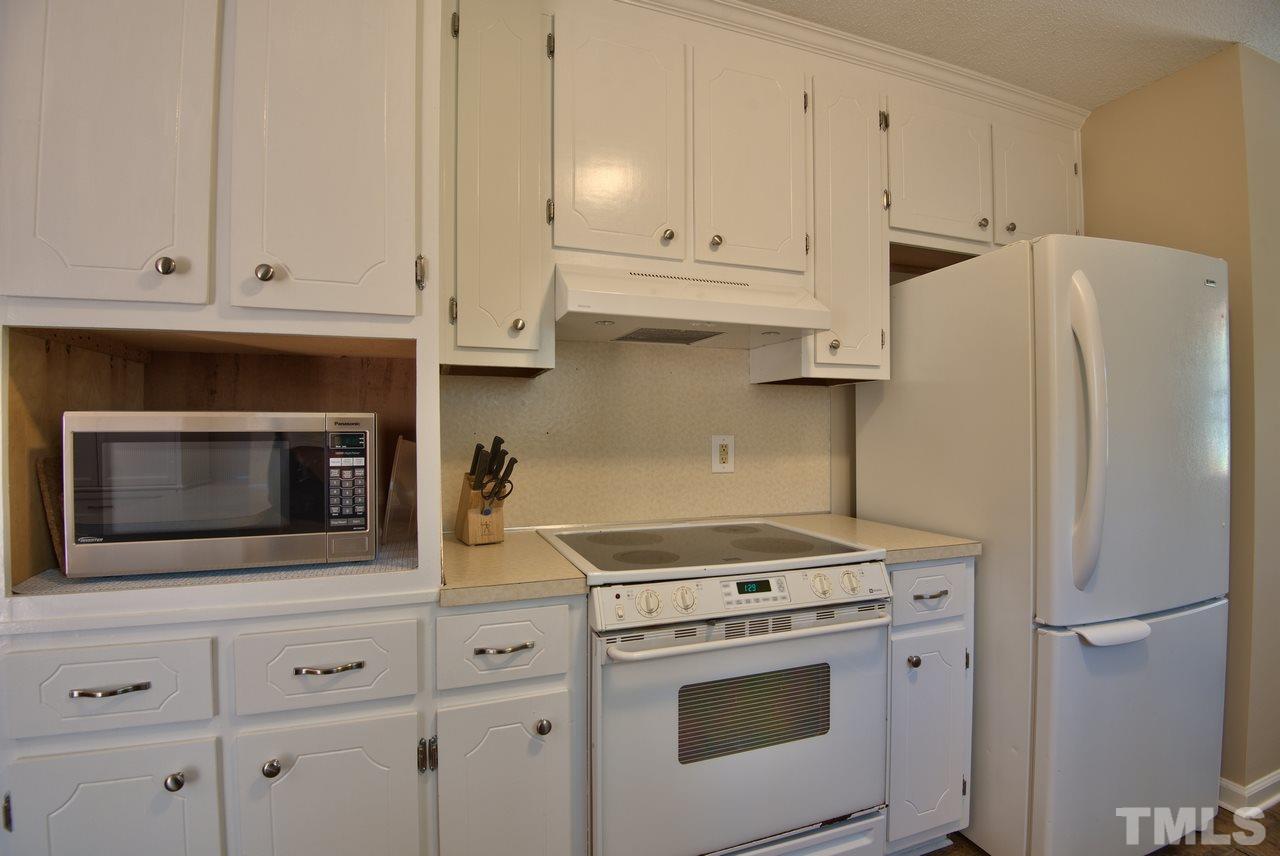 6017 Crabapple Road Durham, NC 27712 - Photo 13 of 18 a kitchen with cabinets and stainless steel appliances