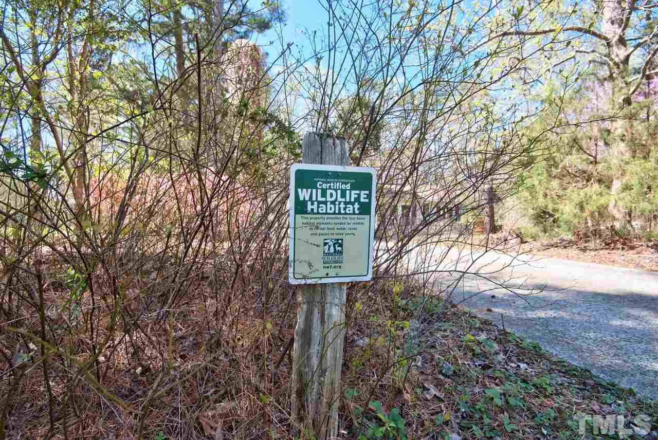 6017 Crabapple Road Durham, NC 27712 - Photo 3 of 18 a sign that is on a brick wall