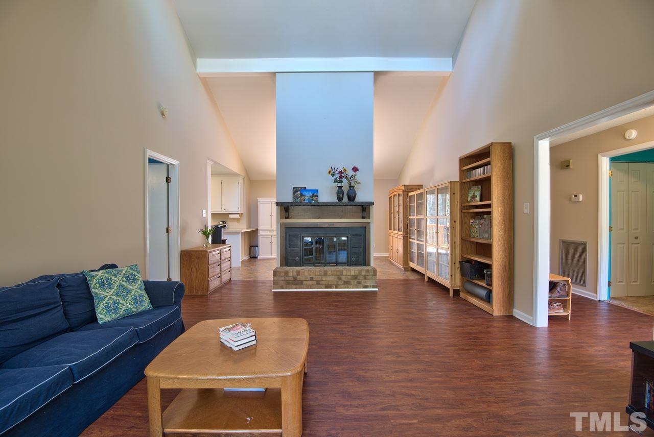 6017 Crabapple Road Durham, NC 27712 - Photo 5 of 18 a living room with furniture and a fireplace