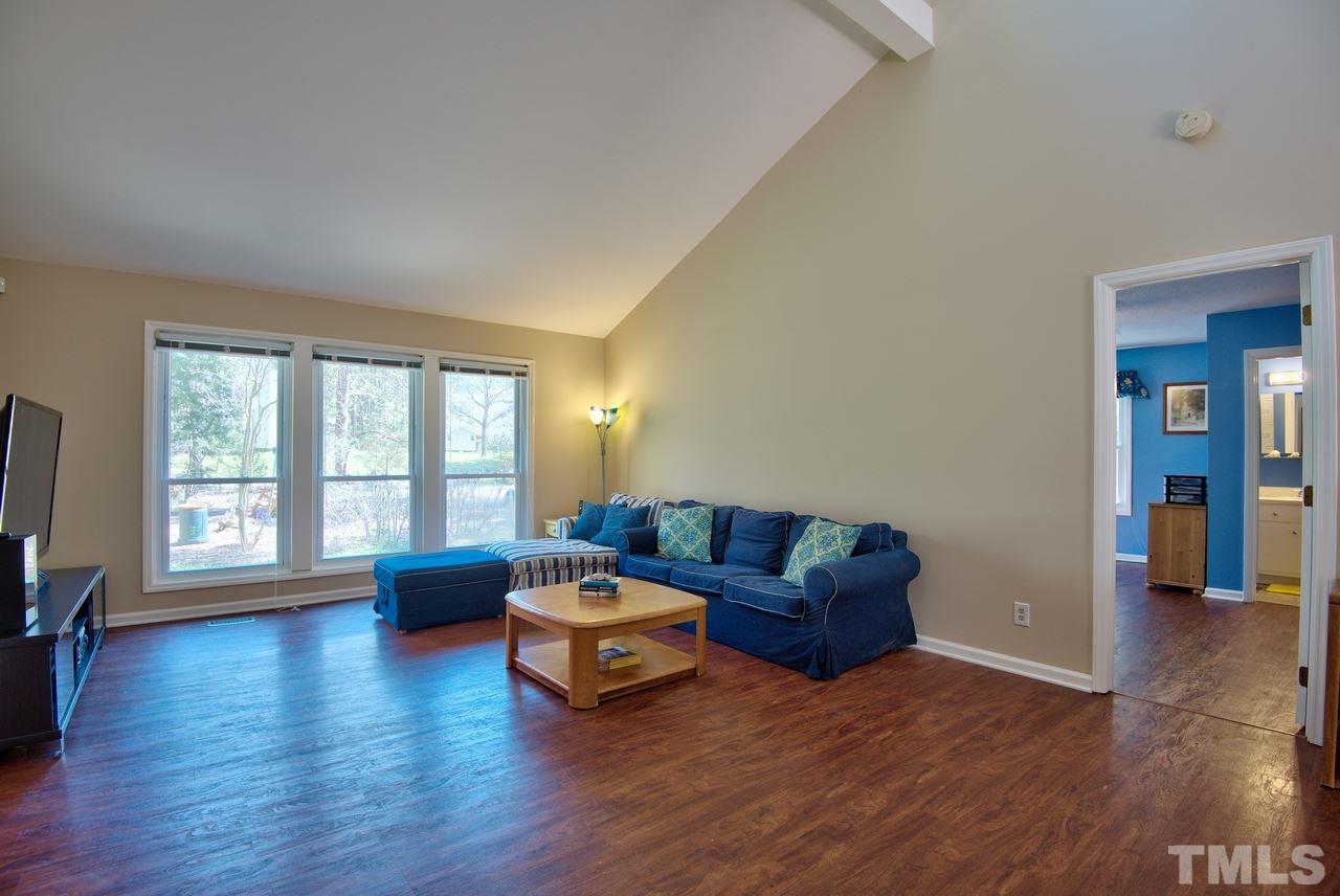 6017 Crabapple Road Durham, NC 27712 - Photo 7 of 18 a living room with furniture window and wooden floor