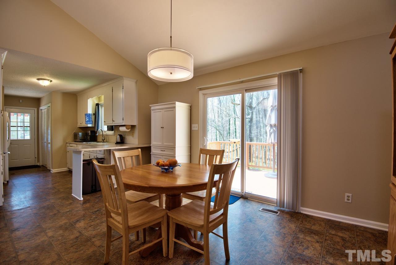 6017 Crabapple Road Durham, NC 27712 - Photo 9 of 18 a view of a dining room with furniture window and wooden floor