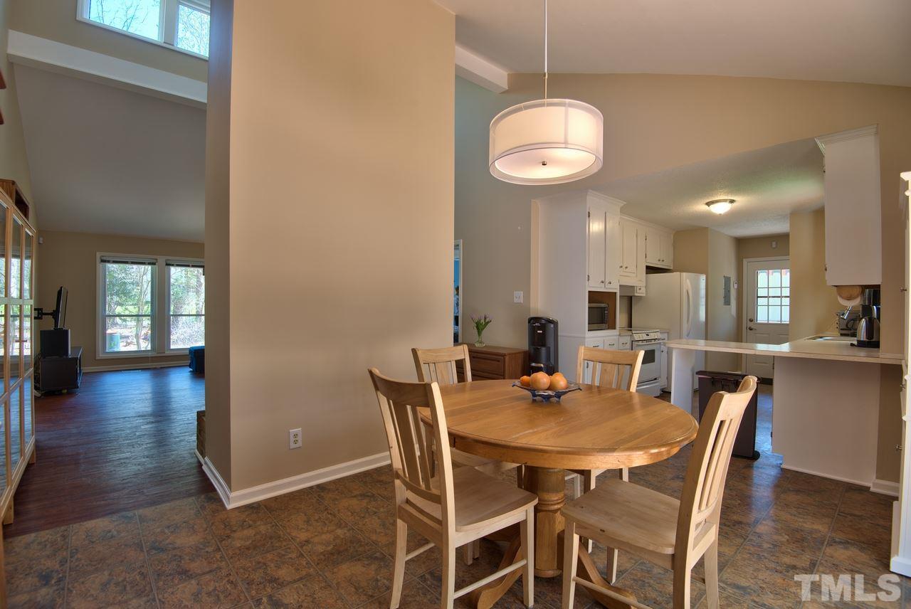 6017 Crabapple Road Durham, NC 27712 - Photo 10 of 18 a view of a dining room with furniture
