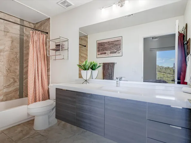 a bathroom with a sink vanity mirror and toilet