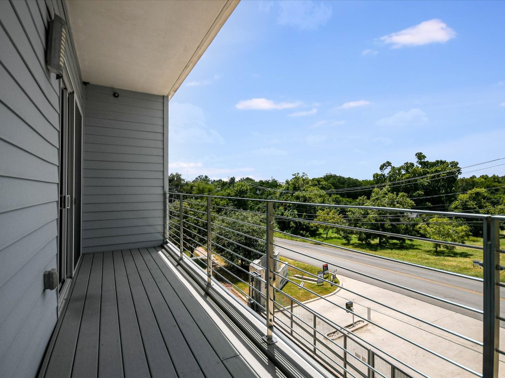 604 North Bluff Drive, Unit 101 Austin, TX 78745 - Photo 18 of 22 a view of balcony with wooden floor and fence