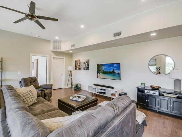 a living room with furniture a table and a potted plant