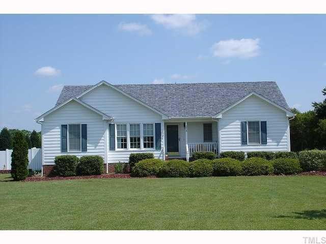 250 Sanders Road Benson, NC 27504 - Photo 1 of 6 a front view of a house with a yard and potted plants