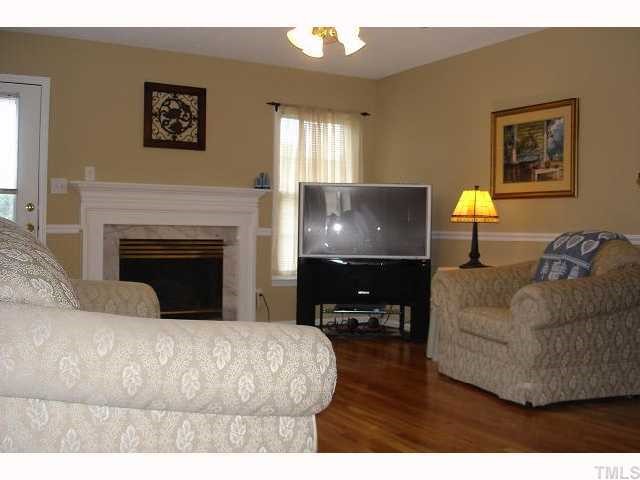 250 Sanders Road Benson, NC 27504 - Photo 3 of 6 a living room with furniture and a fireplace