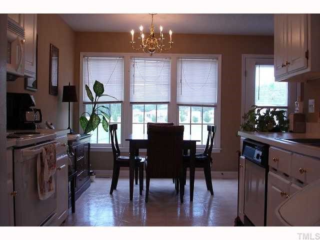 250 Sanders Road Benson, NC 27504 - Photo 4 of 6 a view of a dining room with furniture a chandelier and wooden floor