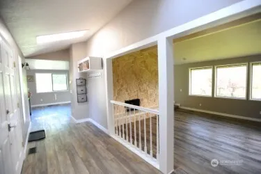 a view of hallway with wooden floor and furniture