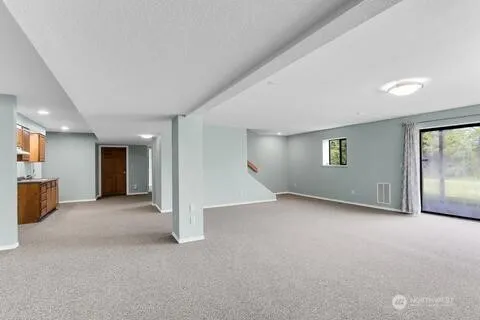 an empty room with windows and closet