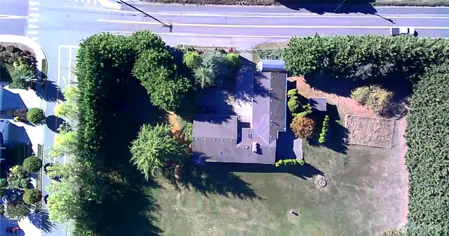 a view of a house with a yard and garden