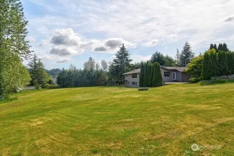 a view of a swimming pool with an outdoor seating and a yard