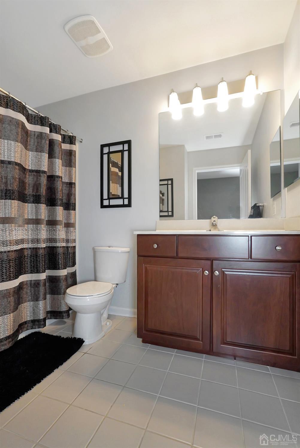 35 Diamond Spring Drive Monroe Township, NJ 08831 - Photo 17 of 32 a bathroom with a sink a toilet and a mirror