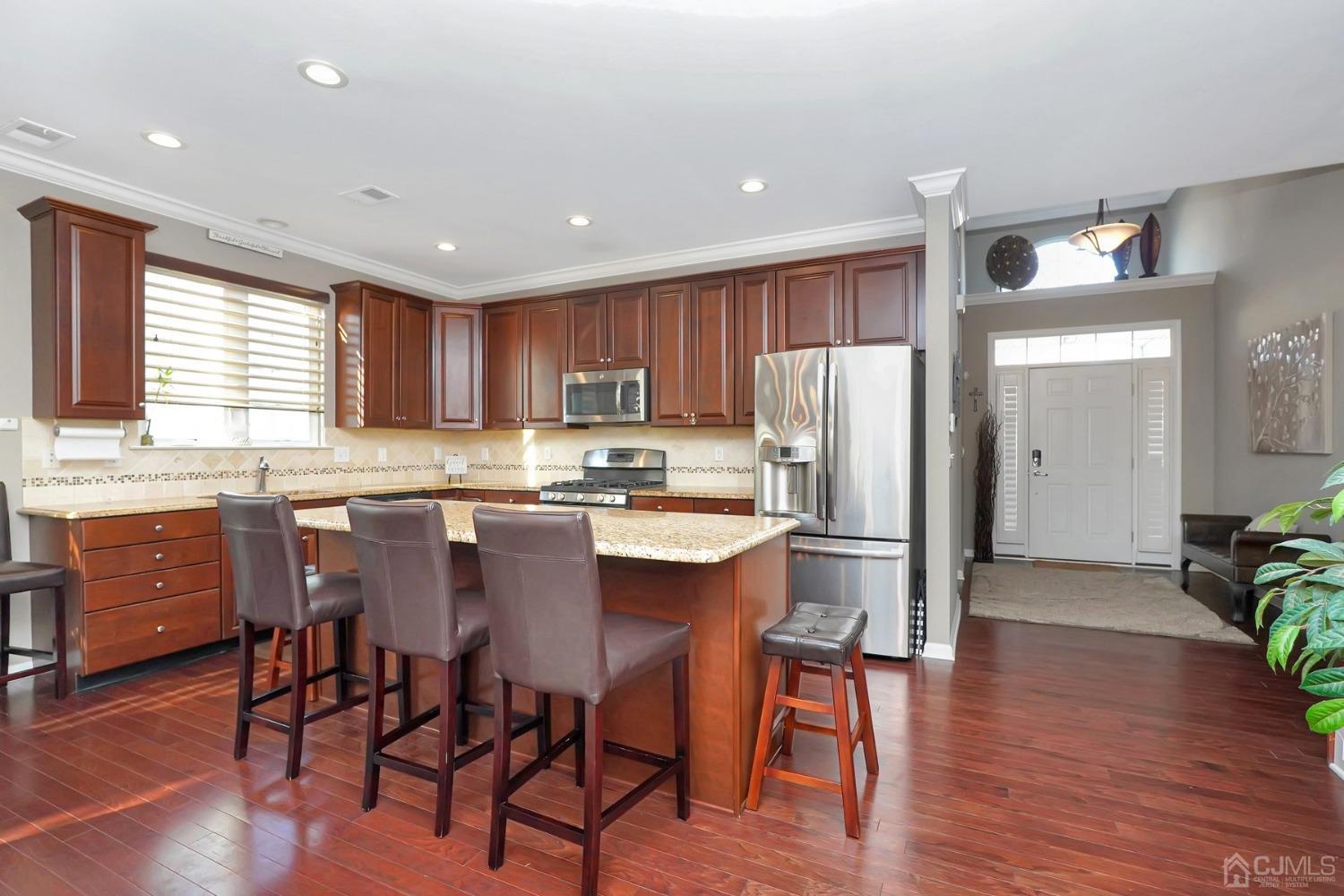 35 Diamond Spring Drive Monroe Township, NJ 08831 - Photo 32 of 32 a kitchen with refrigerator a sink and chairs