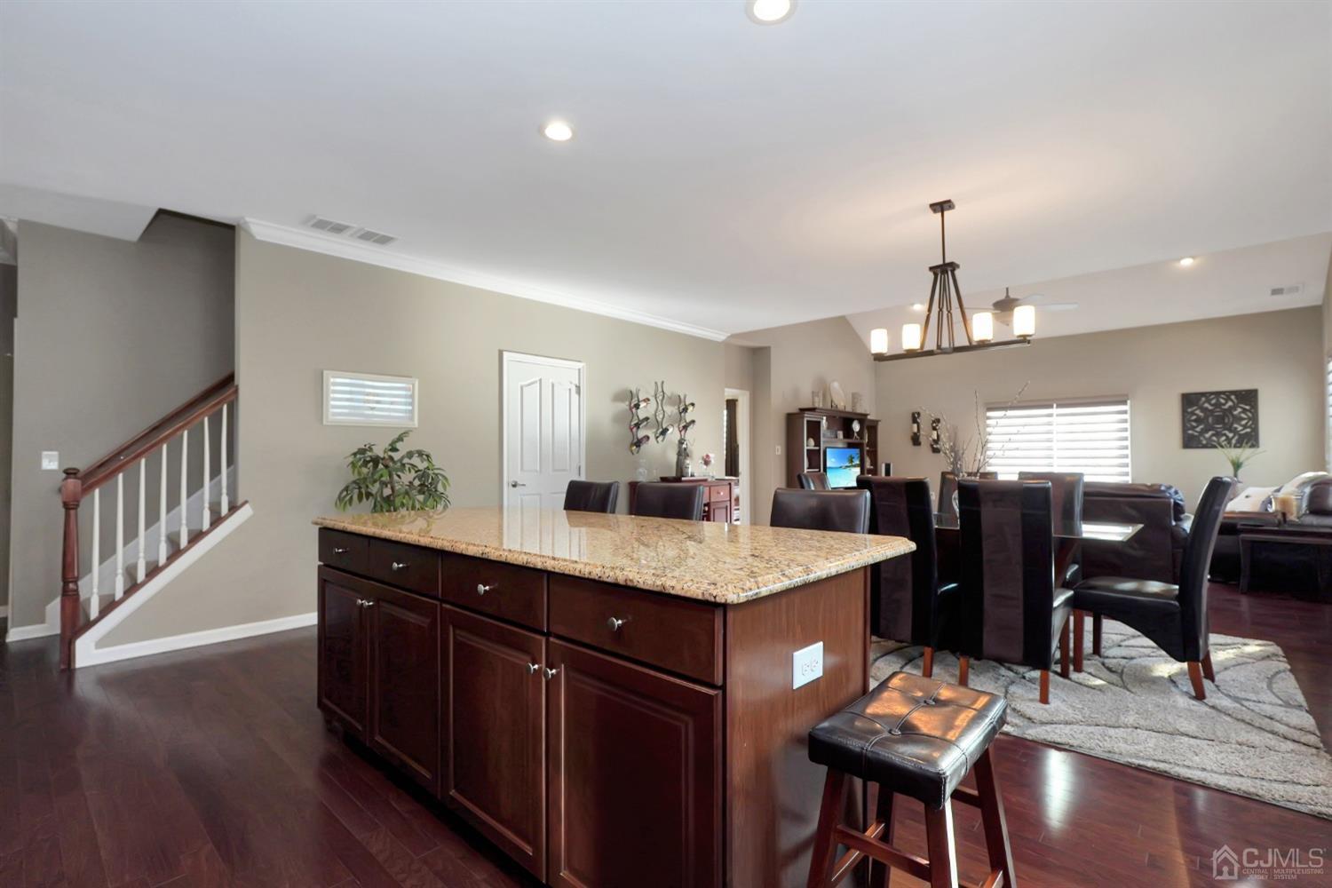 35 Diamond Spring Drive Monroe Township, NJ 08831 - Photo 5 of 32 a view of kitchen island dining room wooden floor and living room