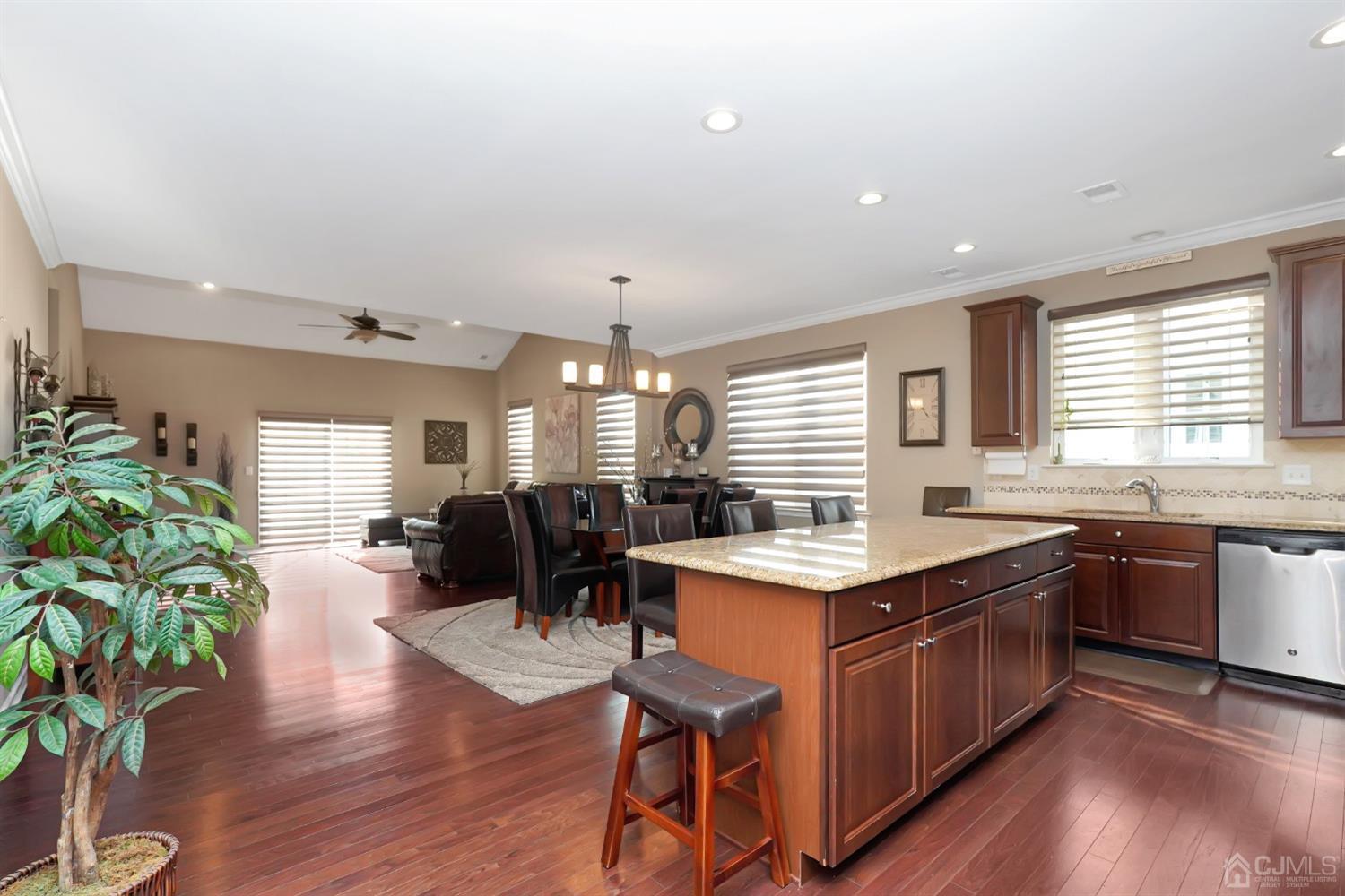 35 Diamond Spring Drive Monroe Township, NJ 08831 - Photo 7 of 32 a kitchen with a table chairs stove a sink dishwasher and cabinets with wooden floor