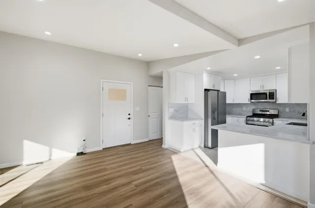 a kitchen with stainless steel appliances granite countertop white cabinets a stove top oven with dishwasher and dishwasher