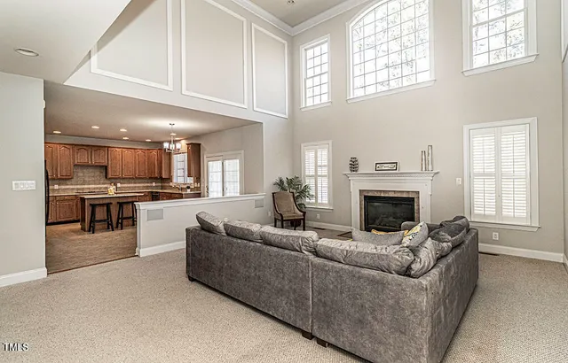 a living room with furniture a fireplace and a window